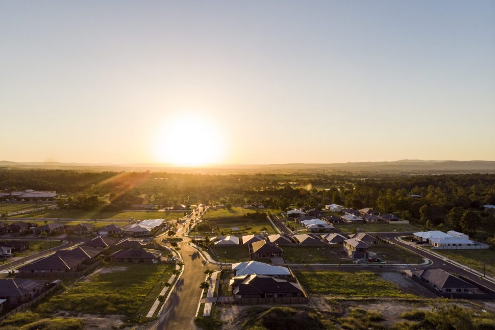 Top view of a small town with a sunrise